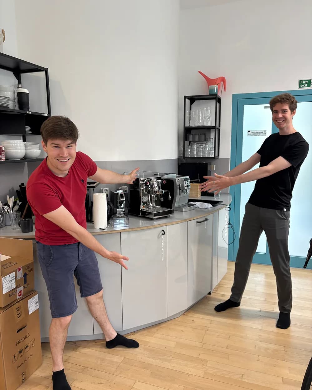 Two of us presenting the office espresso machine the day it arrived
